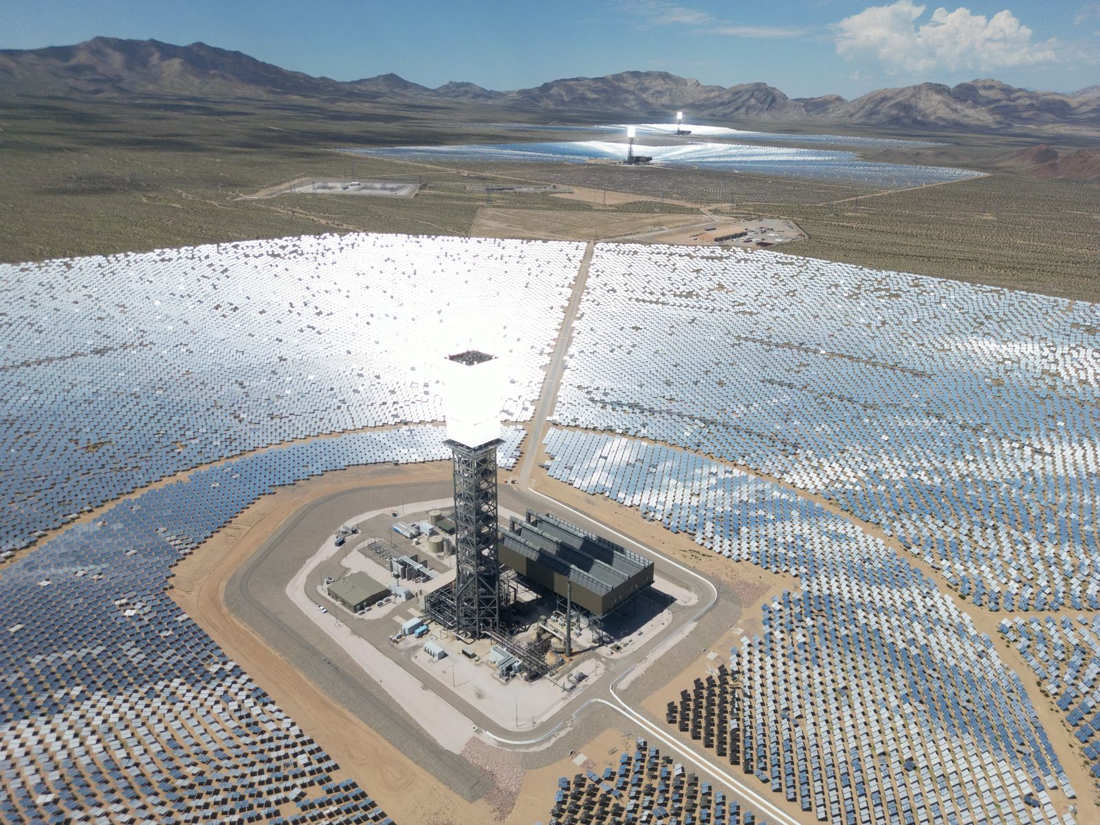 Aerial view of a commercial solar field in rows across San Joaquin Valley farmland