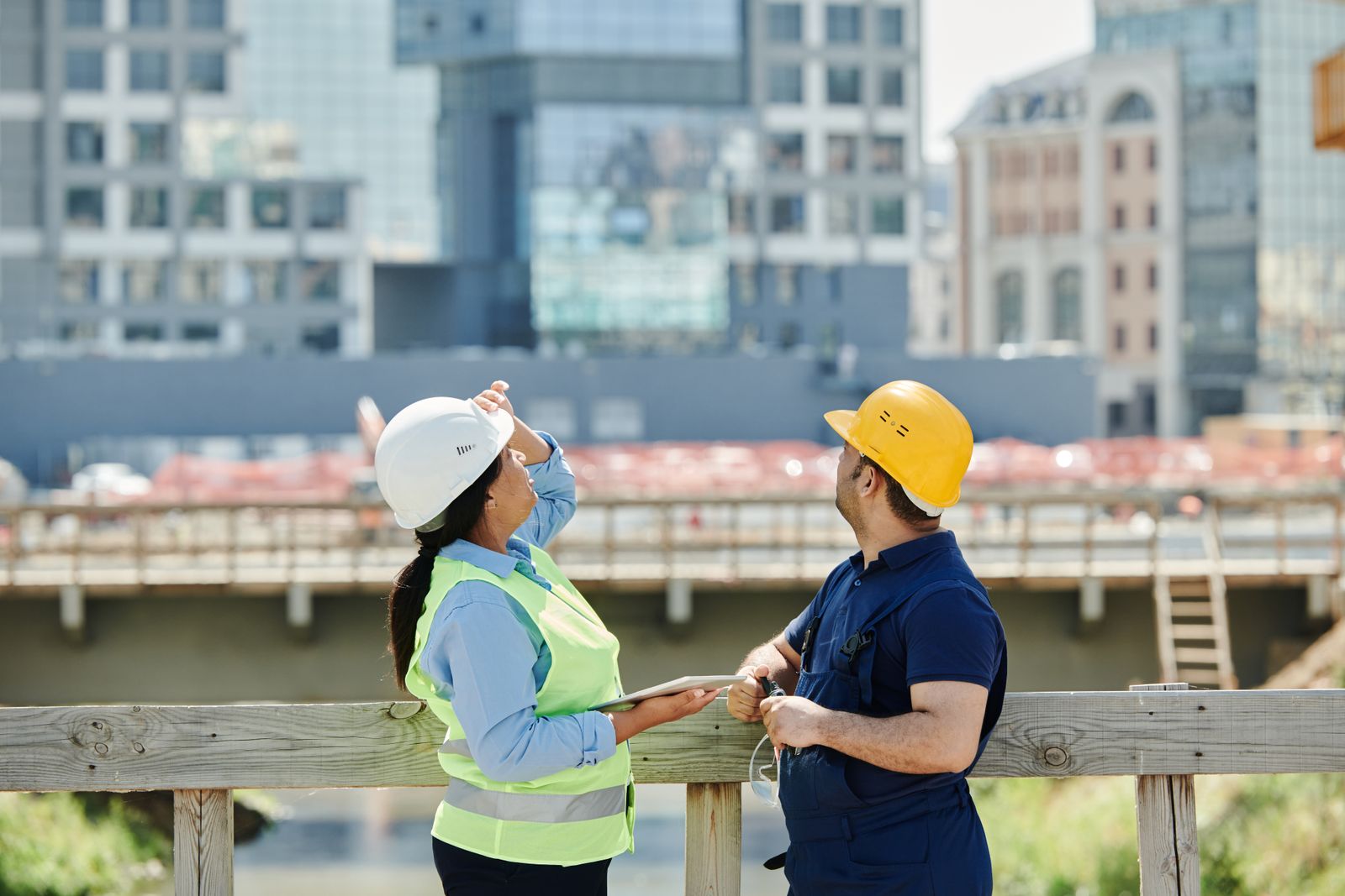Engineers walking a site with drawings